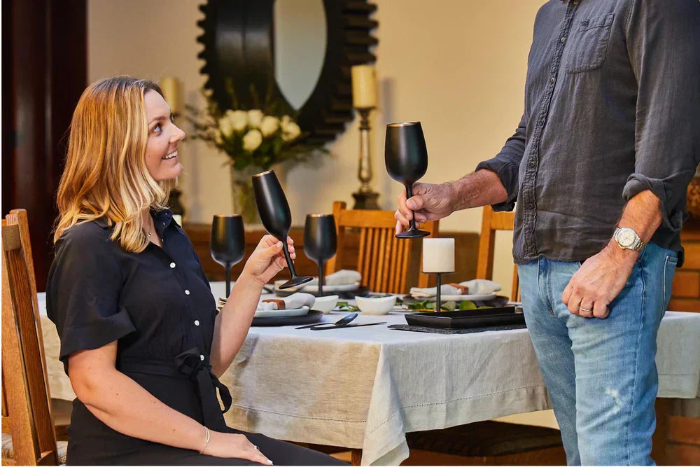 A couple enjoying drinks with Snowfox insulated wine glasses
