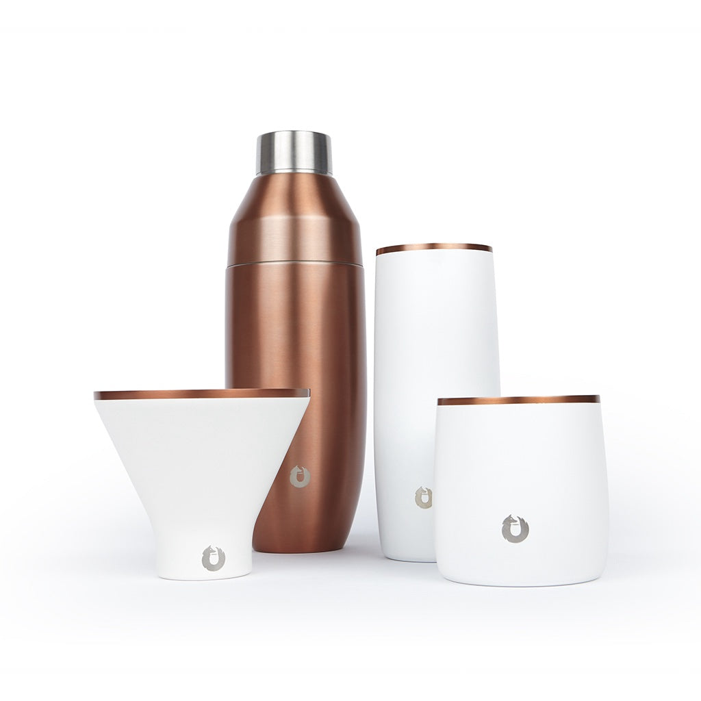 Gold and white cocktail shaker and glasses